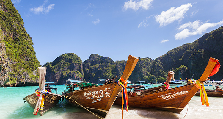 A beautiful beach with boats in Thailand